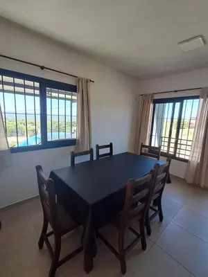 a dining room with a blue table and chairs at Mis tres estrellas 2 in Cavalango