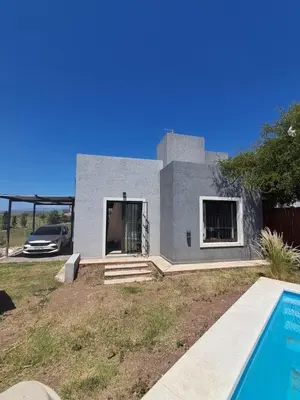 a house with a swimming pool in front of it at Mis tres estrellas 2 in Cavalango