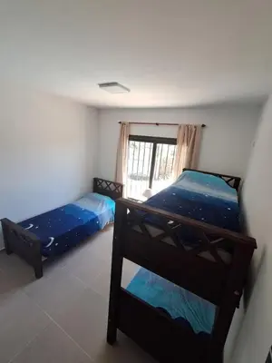 a bedroom with two bunk beds and a window at Mis tres estrellas 2 in Cavalango