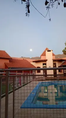 a view of a swimming pool behind a fence at Hostería Sueños Dorados in Merlo