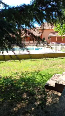 a view of a park with a fence and a tree at Hostería Sueños Dorados in Merlo