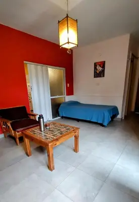 a room with a bed and a table and a couch at Casa de Ceci in Villa Carlos Paz