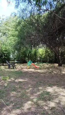 a kite laying on the ground under a tree at Casa de Ceci in Villa Carlos Paz
