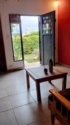 a room with a wooden table and a door with a window at Casa de Ceci in Villa Carlos Paz