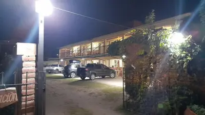 a truck parked in front of a building at night at El Pino Departamentos in Villa Cura Brochero