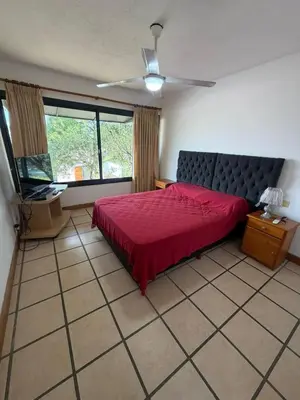 a bedroom with a red bed and a window at Casa Mabel in La Porteña