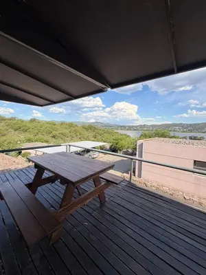 a wooden picnic table on a deck with a view at Casa Mabel in La Porteña