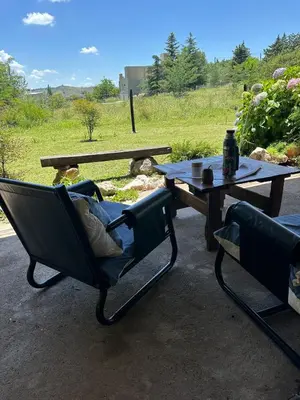 a patio with a table and a chair and a picnic table at Mi lugar Potrero de Garay in La Estancia