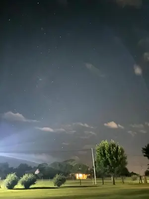 a night view of a field with trees and a sky at Mi lugar Potrero de Garay in La Estancia