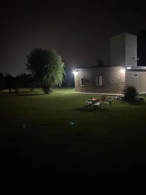 a table and a bench in a field at night at Mi lugar Potrero de Garay in La Estancia