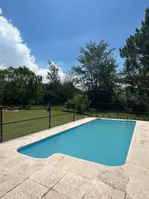a large blue swimming pool in a park at Mi lugar Potrero de Garay in La Estancia
