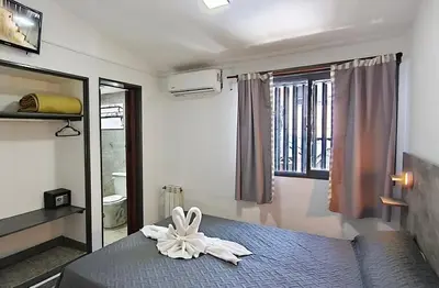 a bedroom with a bed with a white flower on it at new bv carlos paz in Villa Carlos Paz