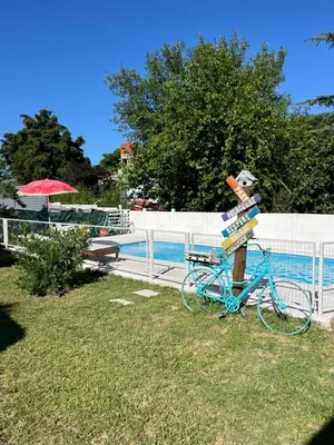 a statue of a bike parked next to a fence at Complejo cerca del rio in Villa Carlos Paz