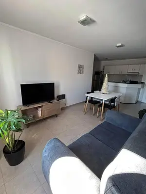 a living room with a couch and a table at Departamento 2 H VIRREY in Villa Carlos Paz
