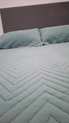 a bed with white sheets and pillows on it at Departamento 2 H VIRREY in Villa Carlos Paz
