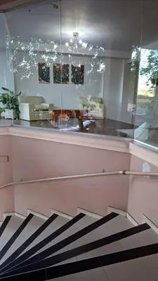 a lobby with a staircase with a glass wall at Departamento 2 H VIRREY in Villa Carlos Paz