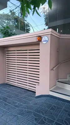 a building with a garage door on a tile floor at Departamento 2 H VIRREY in Villa Carlos Paz