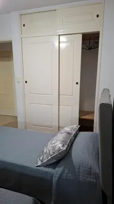a bed with a pillow on it in a bedroom at Departamento 2 H VIRREY in Villa Carlos Paz