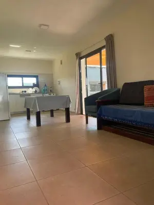 a living room with a couch and a table at Casa de campo Los Gurises in Alta Gracia