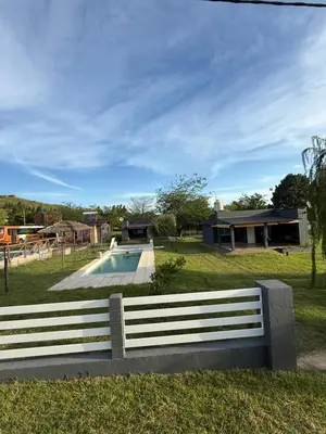 a park with a bench and a swimming pool at Cabañas Marquetti in Potrero de Garay