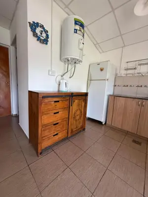 a kitchen with a sink and a refrigerator at Cabañas Marquetti in Potrero de Garay