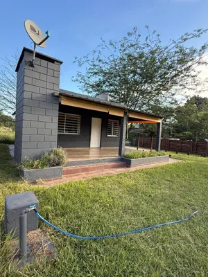 a house with a satellite dish on the grass at Cabañas Marquetti in Potrero de Garay
