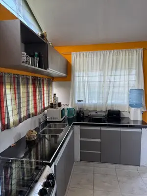 a small kitchen with a sink and a window at El Parador de Tanti in Tanti