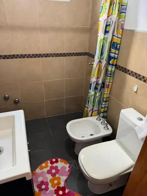 a small bathroom with a toilet and a sink at El Parador de Tanti in Tanti