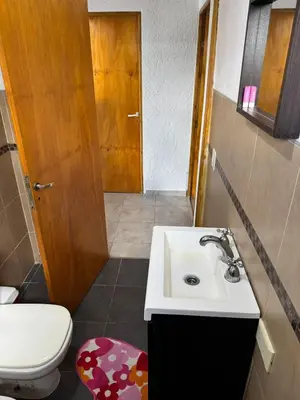 a bathroom with a sink and a toilet at El Parador de Tanti in Tanti