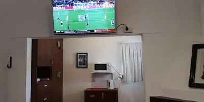 a flat screen tv sitting on top of a room at Habitaciones El Benteveo in Cordoba