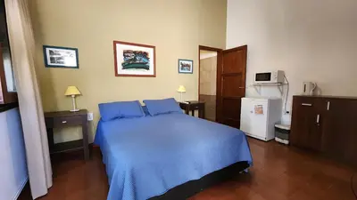 a bedroom with a blue bed in a room at Habitaciones El Benteveo in Cordoba