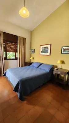 a bedroom with a blue bed in a room at Habitaciones El Benteveo in Cordoba