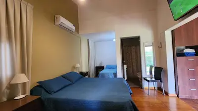 a bedroom with a blue bed in a room at Habitaciones El Benteveo in Cordoba