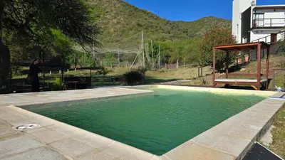 a pool of green water with a person standing next to it at La Soñada in San Roque