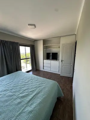 a bedroom with a bed and a tv in it at La Soñada in San Roque