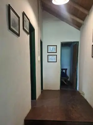 an empty hallway with a hallway leading into a room with paintings at Rincón de Paz in Los Reartes