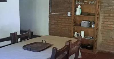 a table with a wooden tray on top of it at Rincón de Paz in Los Reartes