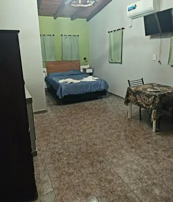 a bedroom with a bed and a table in it at Monoambiente Pilu in Villa Cura Brochero