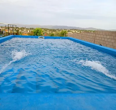 a large swimming pool with blue water at Brisas de las Sierras 2 in Tanti