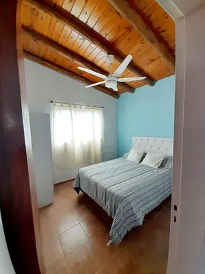 a bedroom with a ceiling fan and a bed at Brisas de las Sierras 2 in Tanti