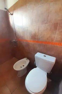 a bathroom with a white toilet and a sink at Brisas de las Sierras 2 in Tanti