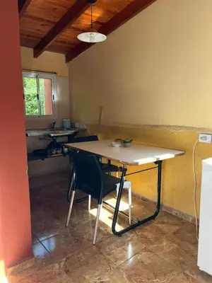 a kitchen with a table and chairs in a room at Siempre verde1 in El Rincón