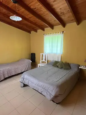 a bedroom with a large bed and a window at Siempre verde1 in El Rincón