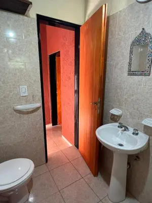 a bathroom with a toilet and a sink at Siempre verde1 in El Rincón