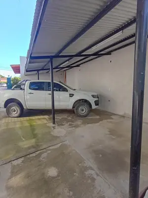a white truck parked in a garage with awning at Siempre verde1 in El Rincón