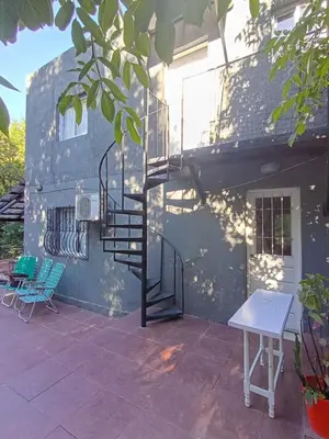 a patio with a spiral staircase next to a building at Siempre verde1 in El Rincón