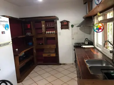 a kitchen with a sink and a counter top at El Sauce casa de verano in Mina Clavero