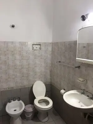 a bathroom with a toilet and a sink at El Sauce casa de verano in Mina Clavero