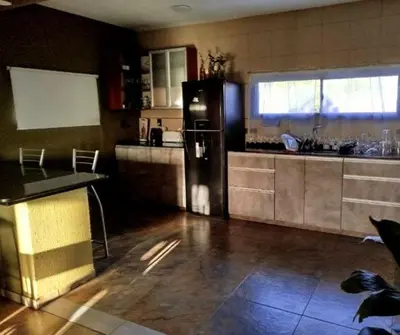 a kitchen with a black refrigerator in a room at Casa grande Flor Silvestre in Carpintería