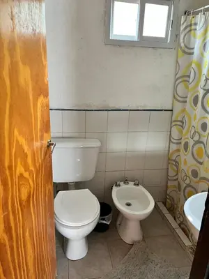 a bathroom with a toilet and a sink at Cabañas La Juana in San Luis